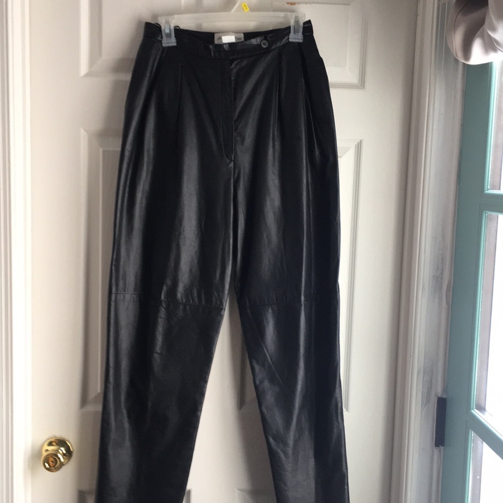 Black leather pants, side pockets, single pleat and button.